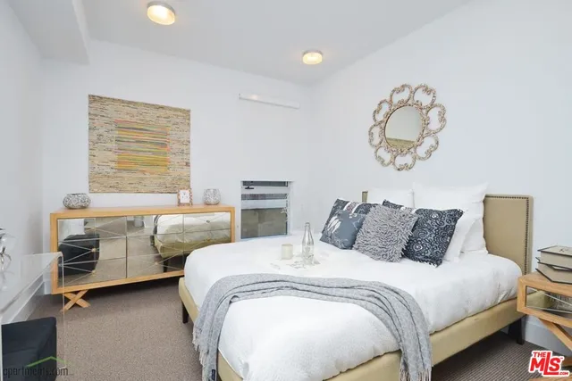 a bedroom with bed and window