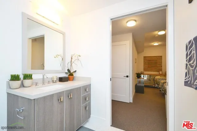 a en suite bathroom with a sink and mirror