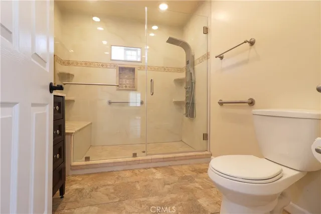 a bathroom with a toilet and a shower