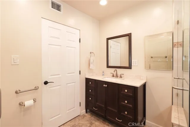 a bathroom with a double vanity sink and mirror
