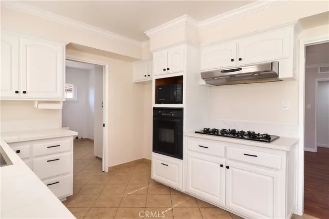 a kitchen with cabinets and appliances