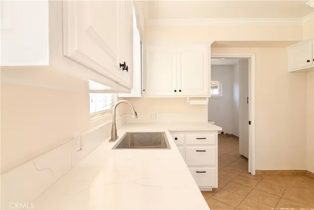 a kitchen with a sink a stove and cabinets