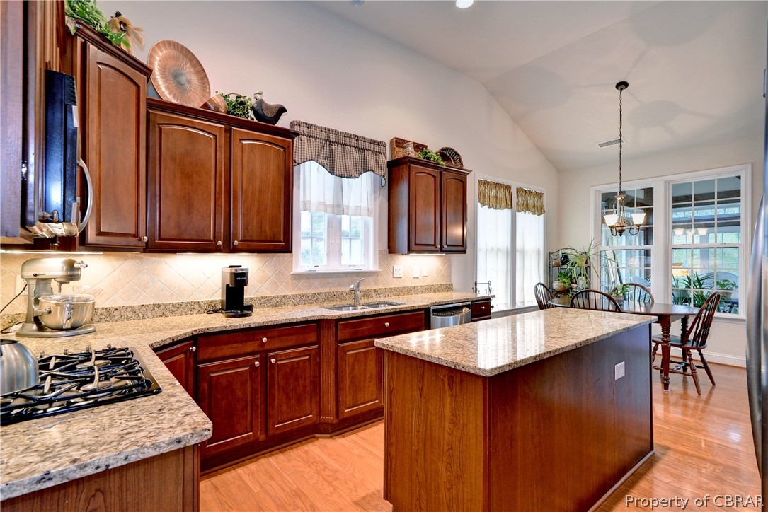4220 Old Lock Road Williamsburg, VA 23188 - Photo 11 of 45 Kitchen offers plenty of storage space, granite counters, tiled backsplash, double ovens, and gas cooktop.