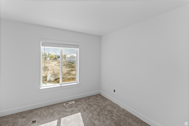 2995 South 265th Street West, Unit 752 Logan, UT 84321 - Photo 14 of 21 Bright room featuring a large window, plush gray carpeting, white baseboards, and neutral wall finishes