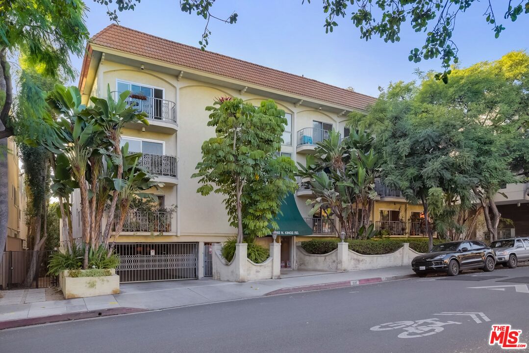 a couple of cars parked in front of a house