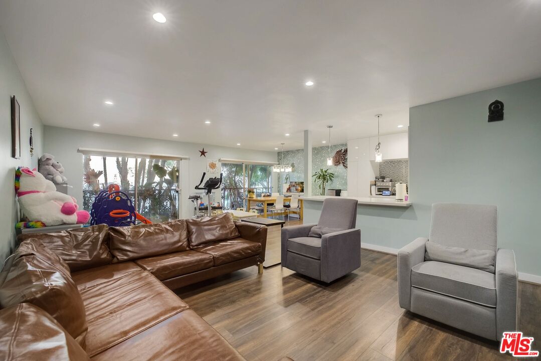 1045 North Kings Road, Unit 102 West Hollywood, CA 90069 - Photo 12 of 15 a living room with furniture and a large window