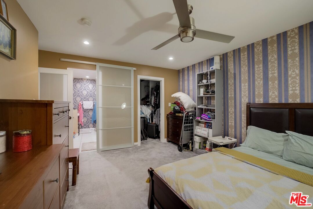 1045 North Kings Road, Unit 102 West Hollywood, CA 90069 - Photo 13 of 15 a bedroom with a bed and a desk