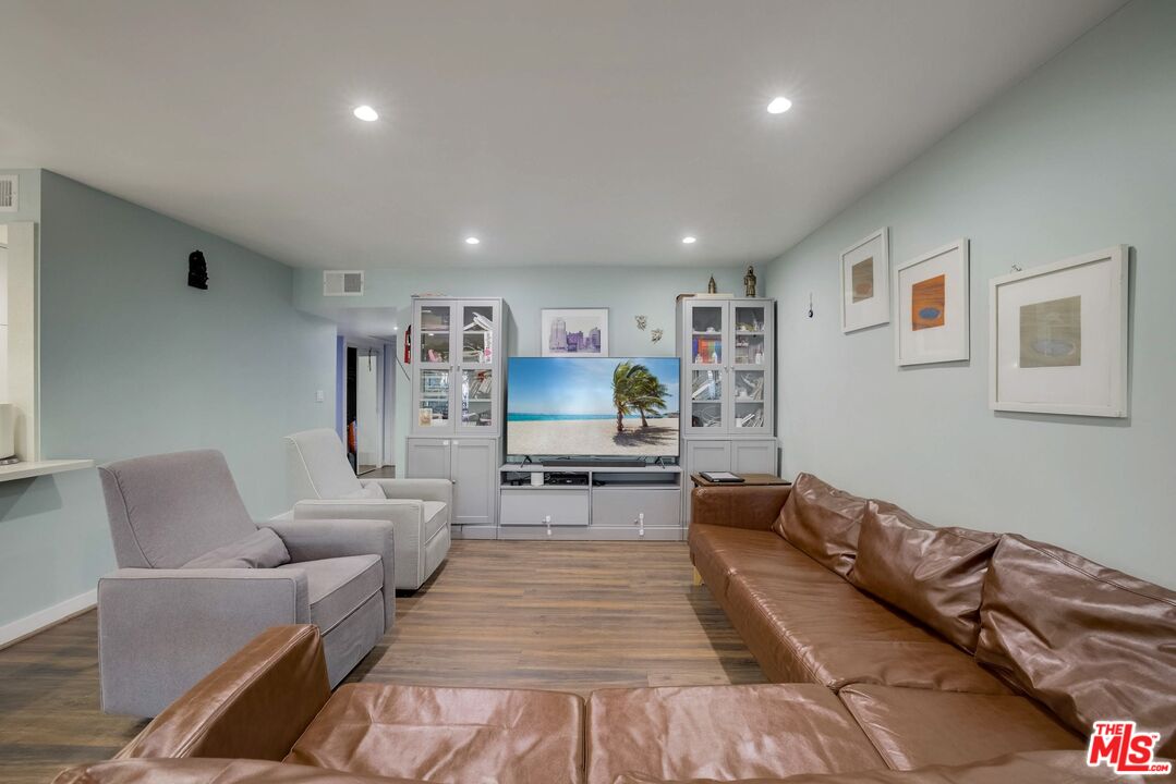 1045 North Kings Road, Unit 102 West Hollywood, CA 90069 - Photo 10 of 15 a living room with furniture and wooden floor