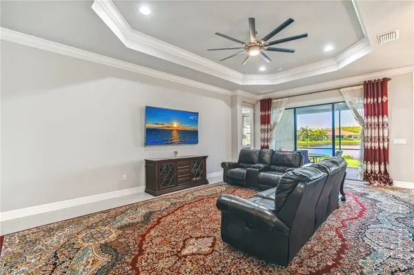 a living room with furniture a large window with a flat screen tv