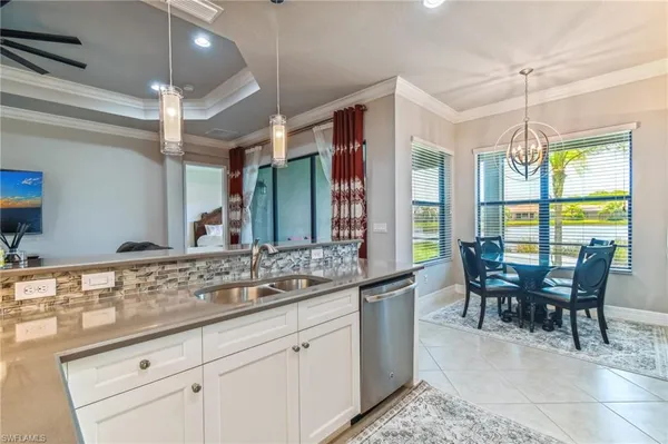 a view of a dining table chairs and chandelier