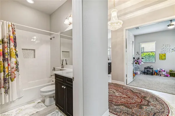 a spacious bathroom with a toilet a sink and shower