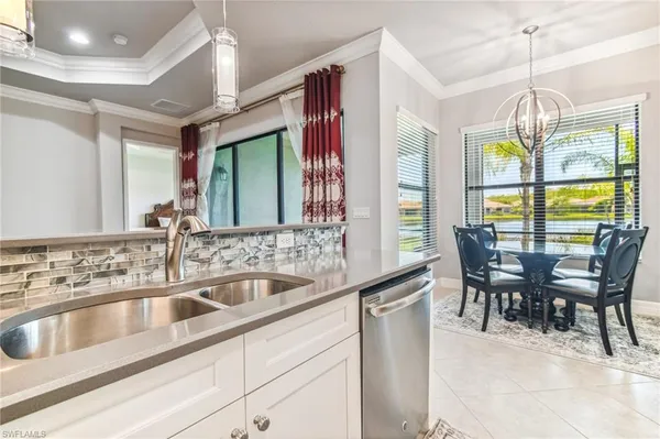 a view of a dining room with furniture a chandelier and chandelier
