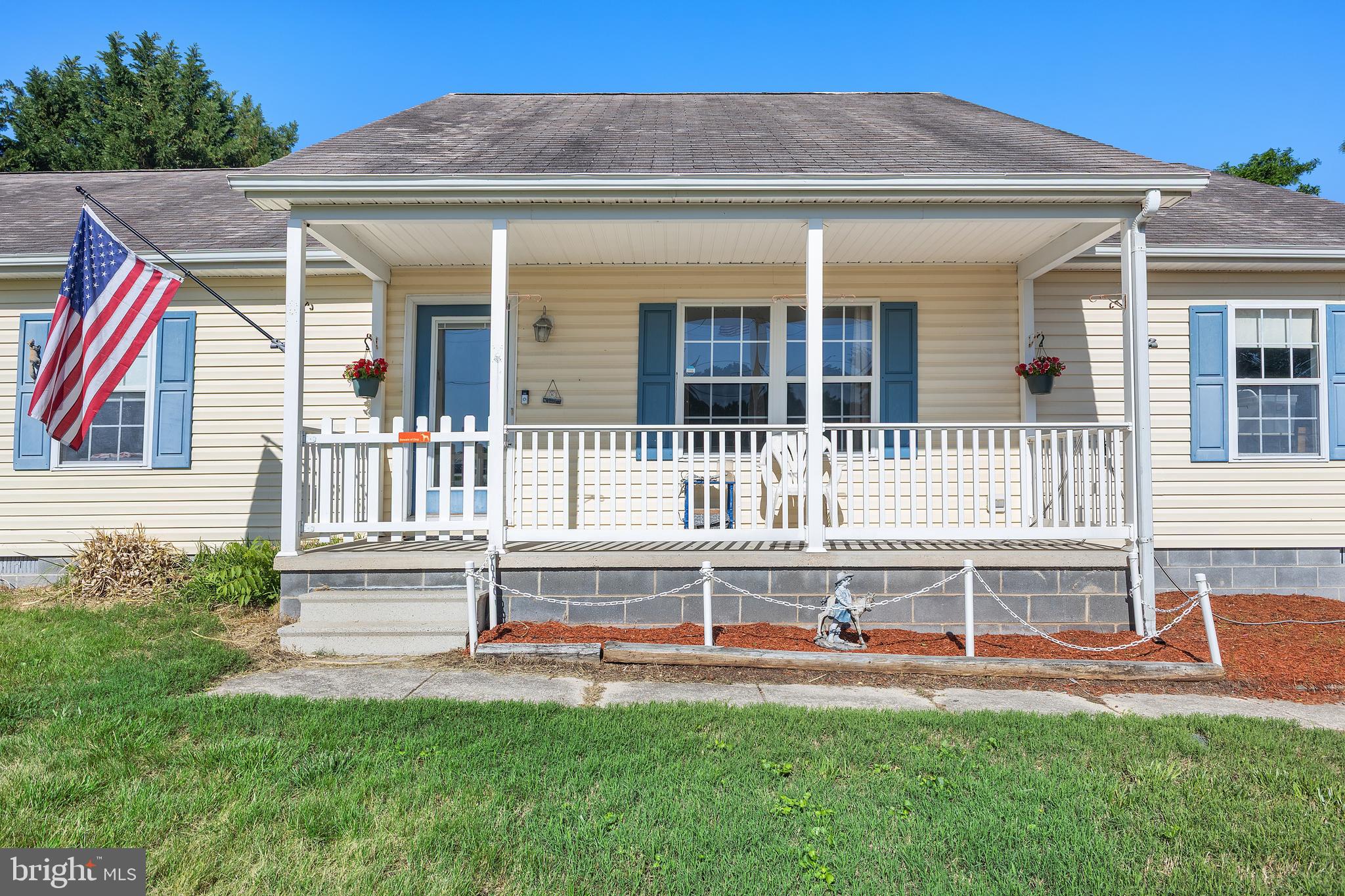 7112 East New Market Ellwood Road Hurlock, MD 21643 - Photo 22 of 41 a front view of a house with a yard and a fence