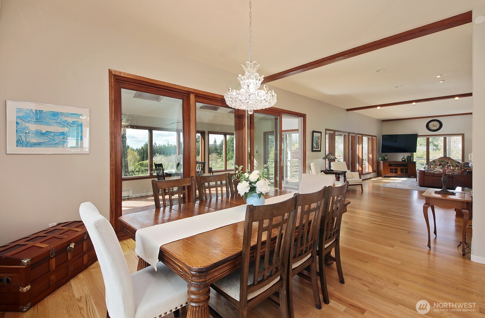 5741 Crow Haven Road Langley, WA 98260 - Photo 25 of 40 a dining room with furniture a chandelier and wooden floor