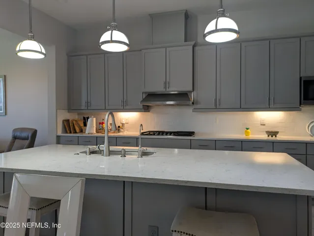 a kitchen with granite countertop cabinets and white appliances