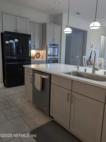 a kitchen with granite countertop a stove and a microwave