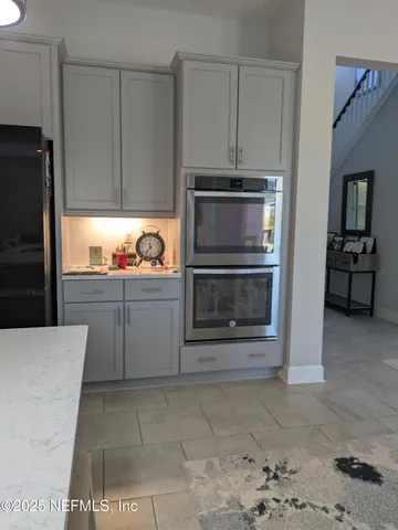 a room with wooden floor pool table and chairs