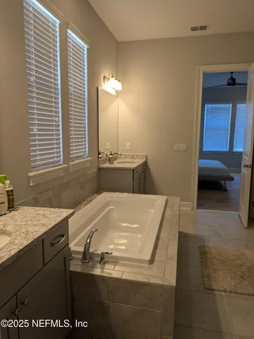 a bathroom with a sink a vanity and a mirror