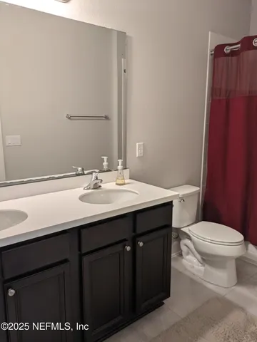 a living room with furniture and a ceiling fan