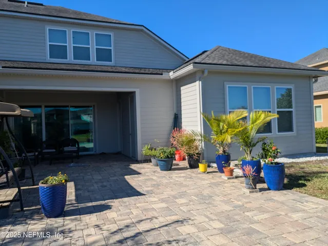 a view of a house with a yard and plants