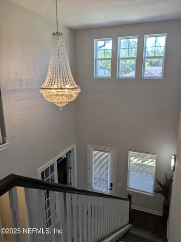 a view of a hallway with a dining table and chairs