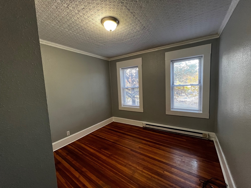 691 State Street Springfield, MA 01109 - Photo 14 of 18 a view of an empty room with wooden floor and a window