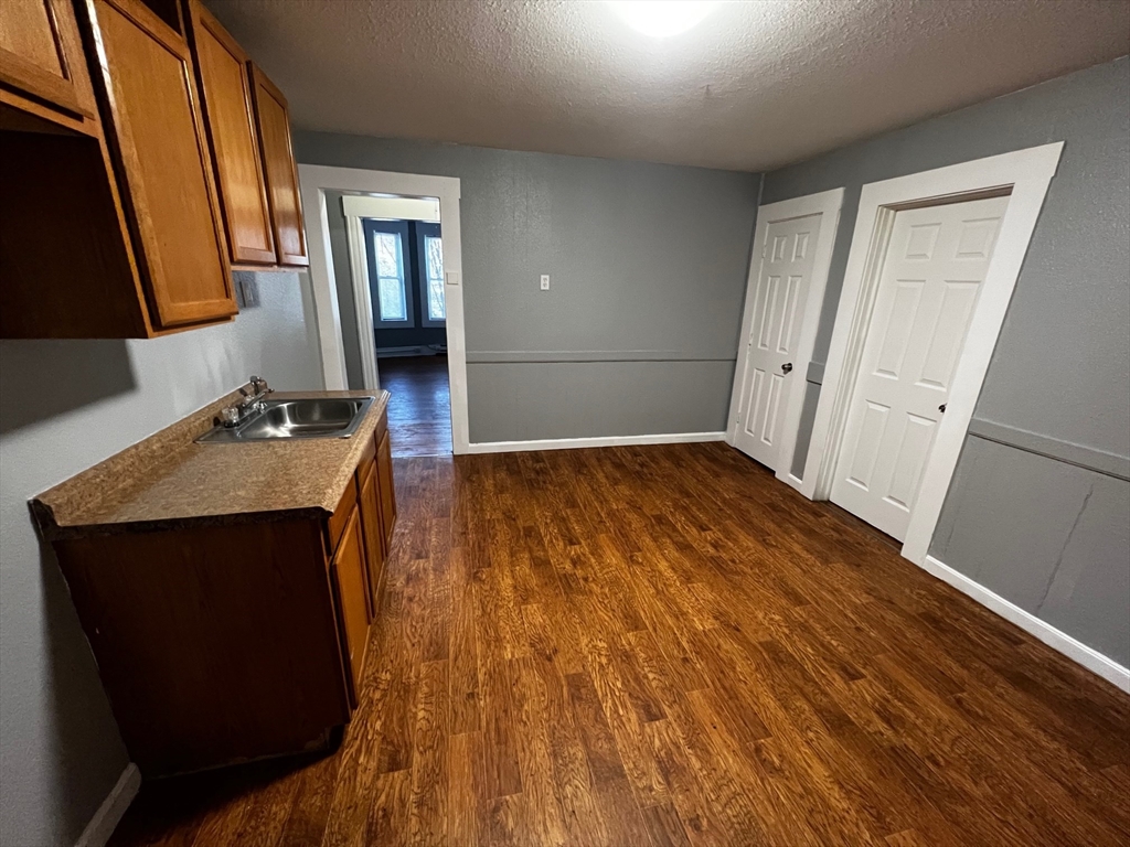 691 State Street Springfield, MA 01109 - Photo 5 of 18 a room with wooden floor and mirror