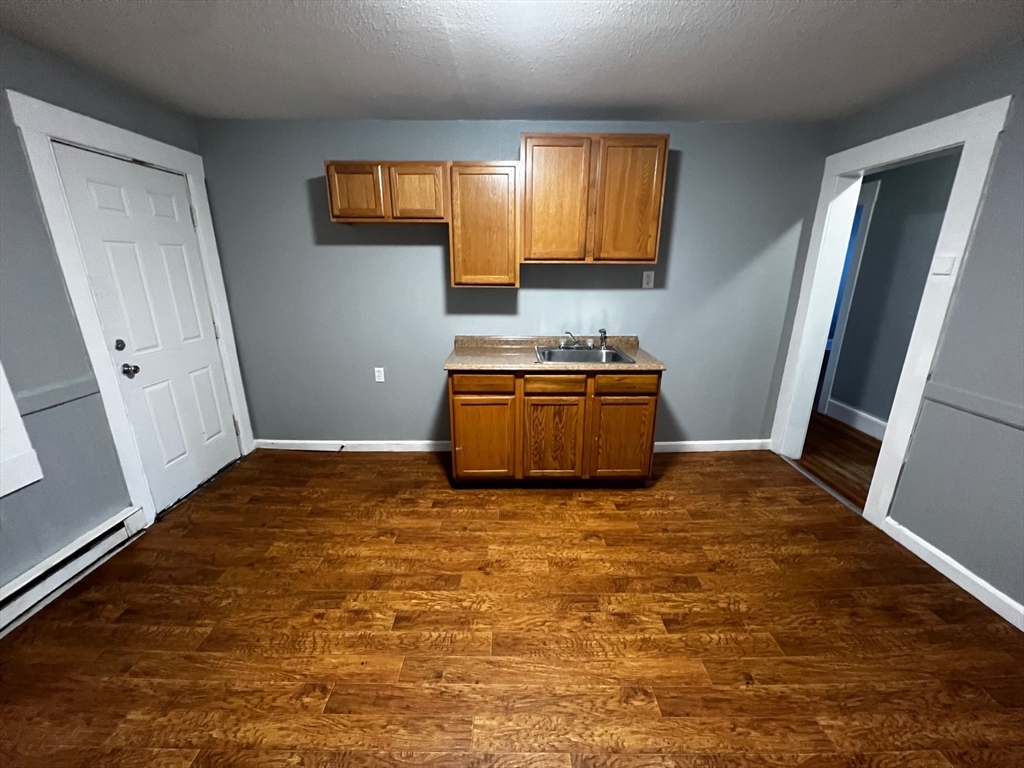 691 State Street Springfield, MA 01109 - Photo 6 of 18 a kitchen with granite countertop a stove a sink and a refrigerator