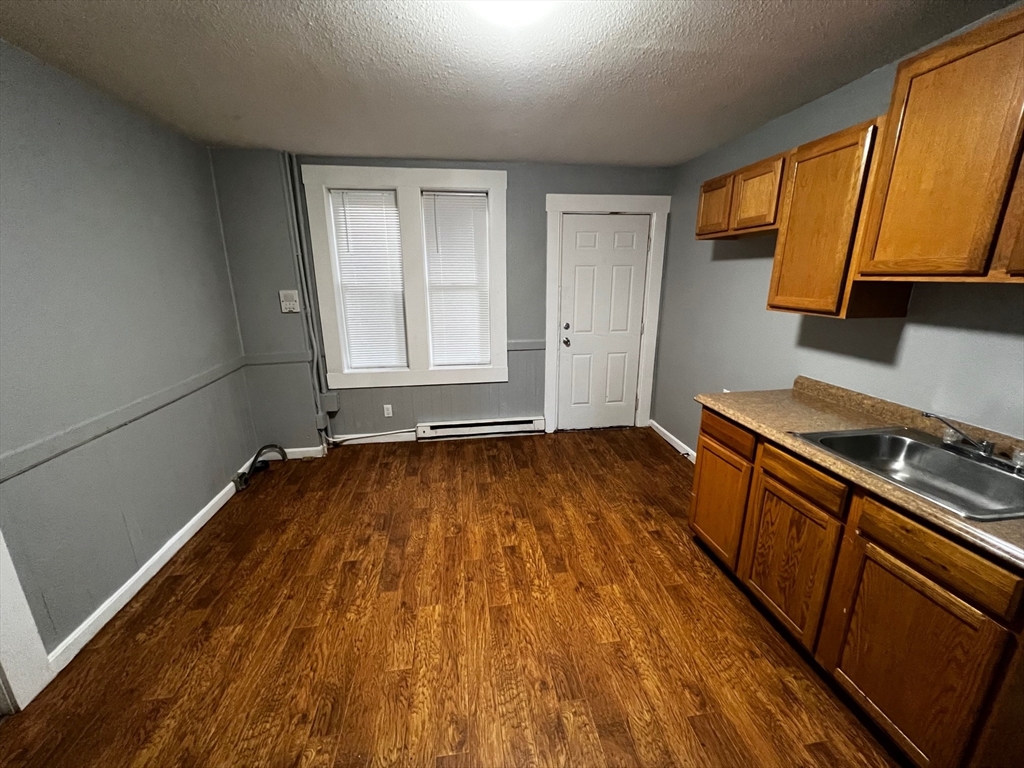 691 State Street Springfield, MA 01109 - Photo 7 of 18 a view of a kitchen with wooden floor and electronic appliances