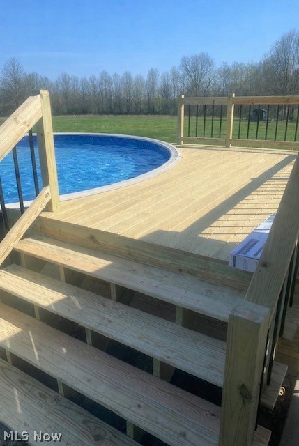 8742 Henderson Road Diamond, OH 44412 - Photo 37 of 37 30-foot round above ground pool (2018) with wooden deck (2023)