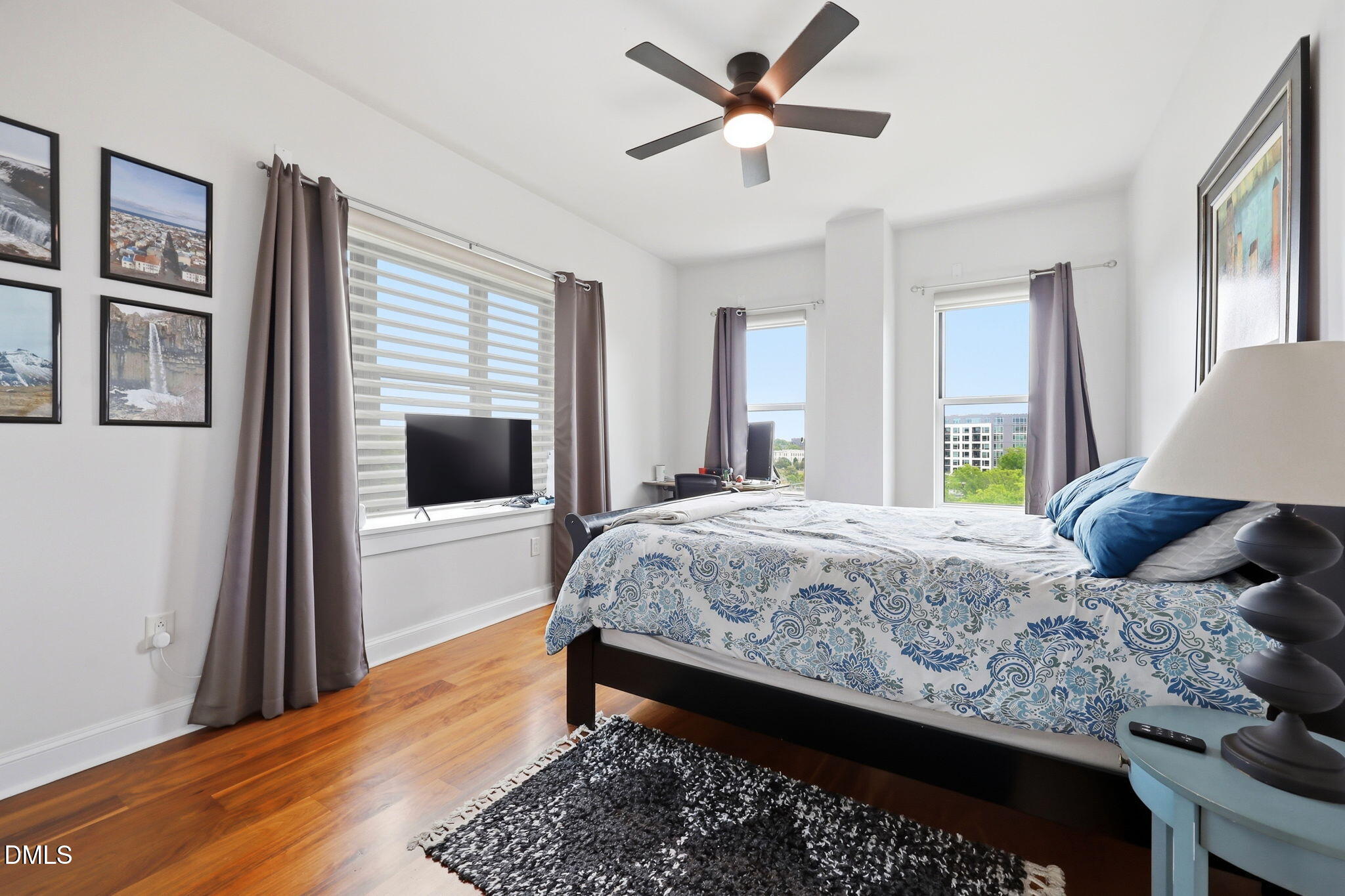 618 North Boylan Avenue, Unit 718 Raleigh, NC 27603 - Photo 18 of 38 a bedroom with a large bed and a chandelier