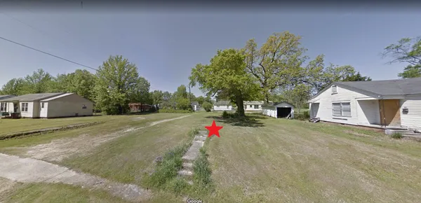a flower garden is sitting in front of a house