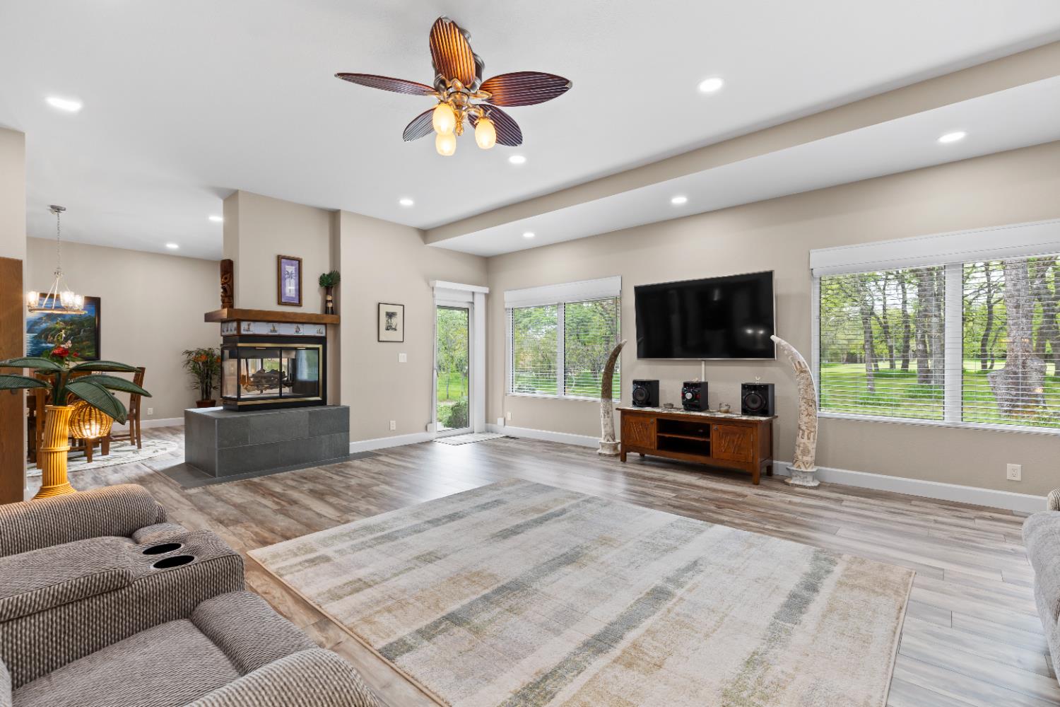 1222 Fruitvale Road Lincoln, CA 95648 - Photo 23 of 90 a living room with furniture and a flat screen tv with kitchen view