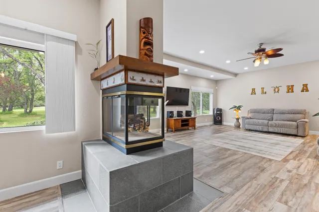 a living room with pool table and a floor to ceiling window
