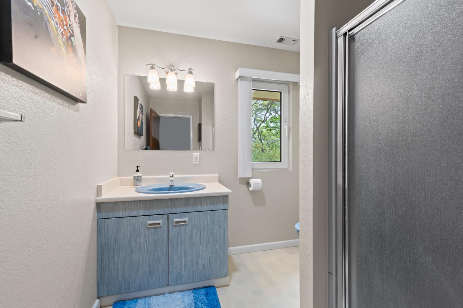 1222 Fruitvale Road Lincoln, CA 95648 - Photo 63 of 90 a bathroom with a double vanity sink and a mirror