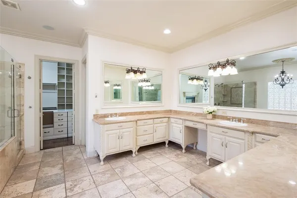 a large white kitchen with a sink and cabinets