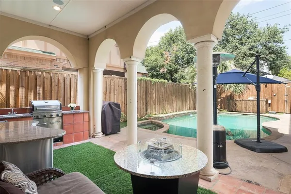 a view of a patio with table and chairs potted plants with wooden floor and fence