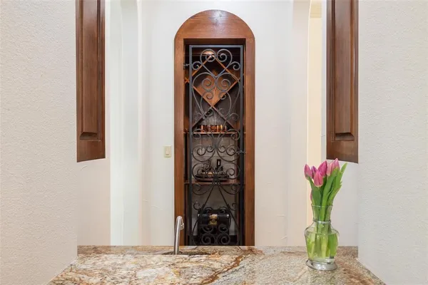 a view of a hallway with wooden floor and a potted plant