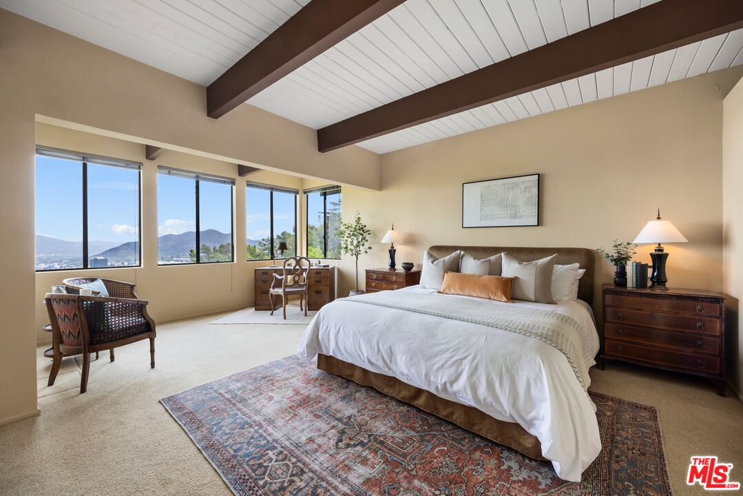 3230 Wrightwood Drive Studio City, CA 91604 - Photo 18 of 43 a spacious bedroom with a large bed and a couch