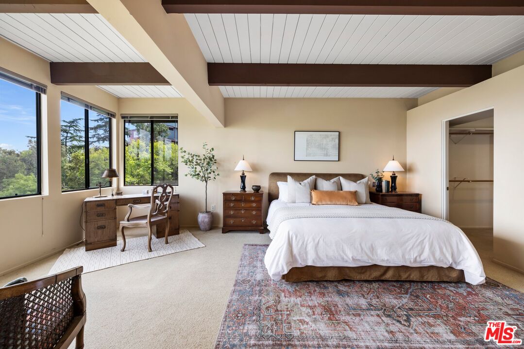 3230 Wrightwood Drive Studio City, CA 91604 - Photo 19 of 43 a spacious bedroom with a large bed and a large window