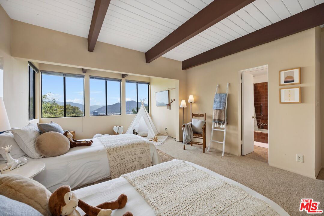 3230 Wrightwood Drive Studio City, CA 91604 - Photo 25 of 43 a bedroom with a bed and glass door