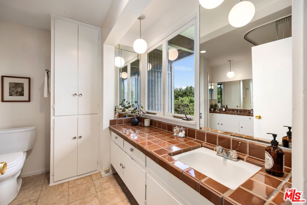 3230 Wrightwood Drive Studio City, CA 91604 - Photo 27 of 43 a bathroom with a granite countertop sink and a large mirror