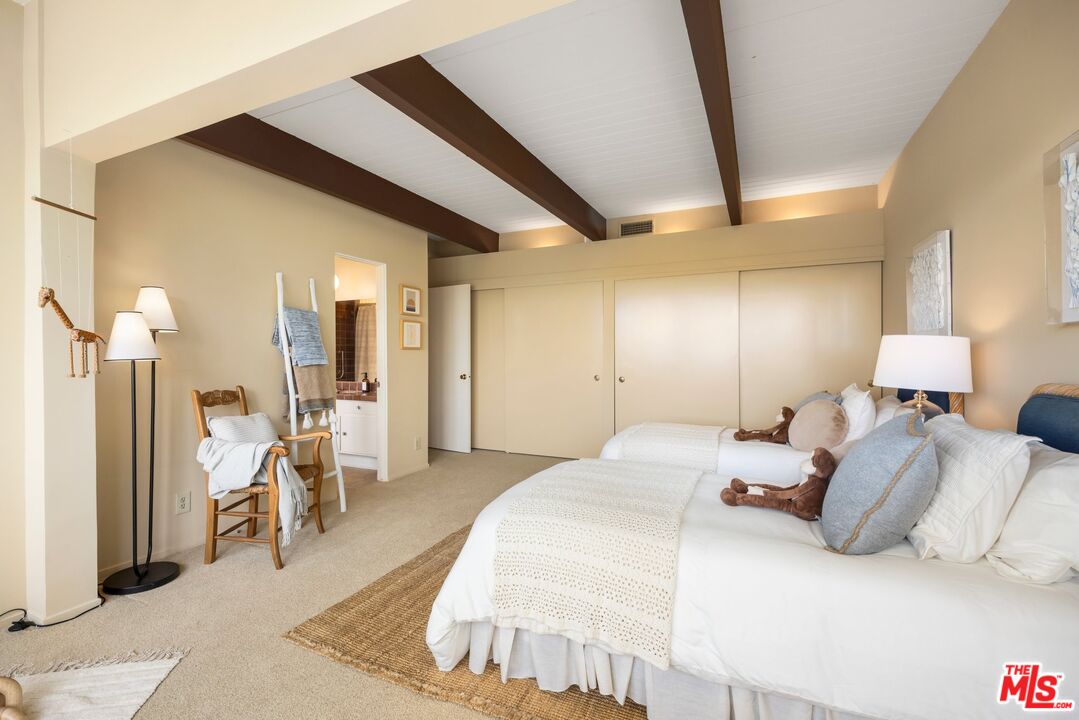 3230 Wrightwood Drive Studio City, CA 91604 - Photo 29 of 43 a spacious bedroom with a bed and a large mirror