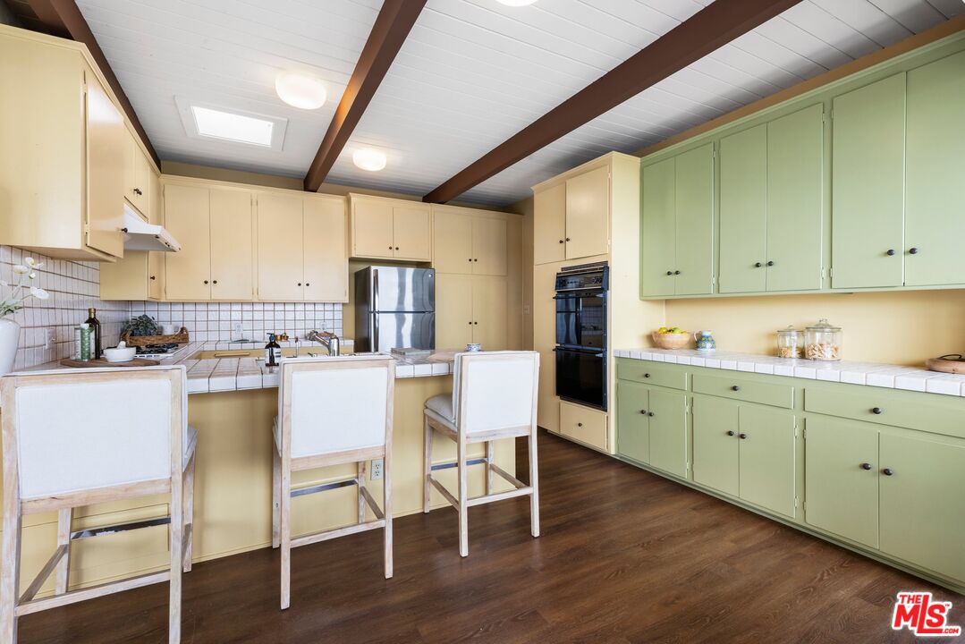 3230 Wrightwood Drive Studio City, CA 91604 - Photo 10 of 43 a kitchen with granite countertop cabinets table and chairs