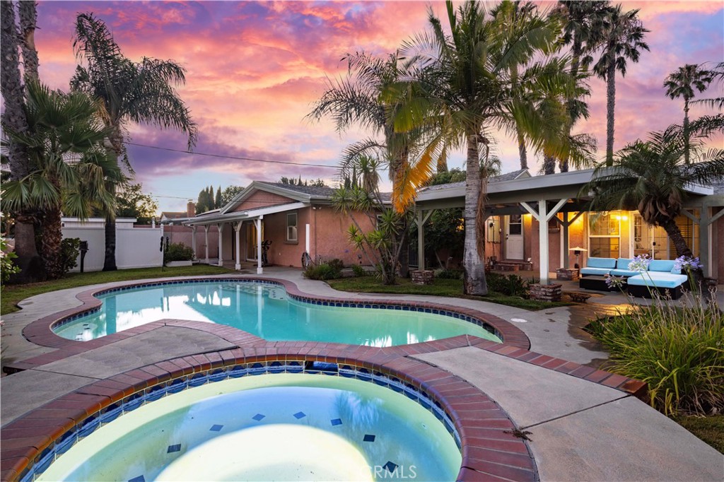 a front view of a house with swimming pool having outdoor seating