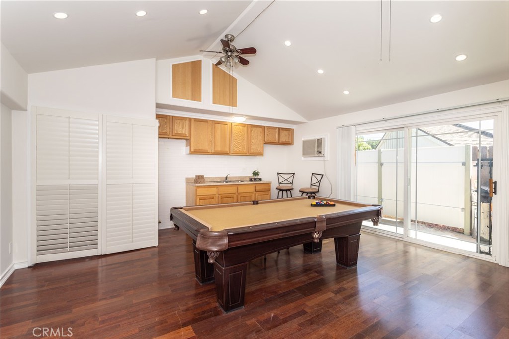 18308 Lahey Street Porter Ranch, CA 91326 - Photo 11 of 41 a room with stainless steel appliances kitchen island granite countertop a table chairs and a refrigerator