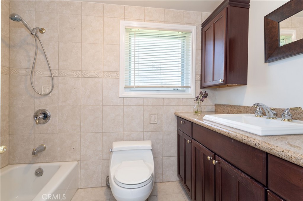 18308 Lahey Street Porter Ranch, CA 91326 - Photo 27 of 41 a bathroom with a granite countertop sink toilet and shower