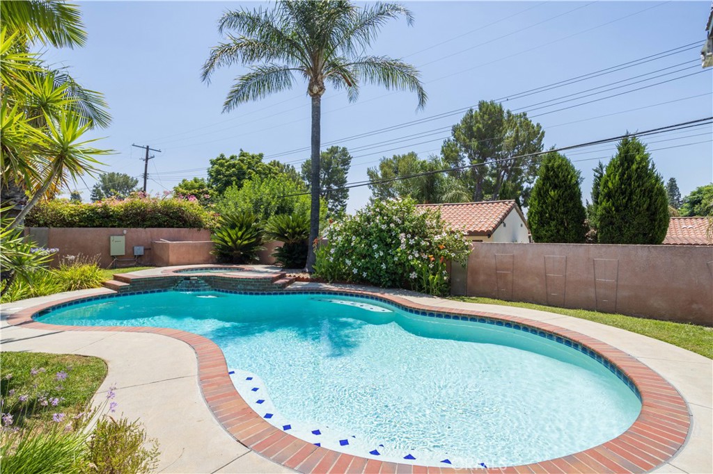 18308 Lahey Street Porter Ranch, CA 91326 - Photo 31 of 41 a view of a swimming pool with a yard