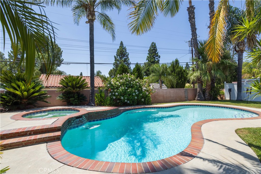 18308 Lahey Street Porter Ranch, CA 91326 - Photo 34 of 41 a view of a swimming pool with a garden