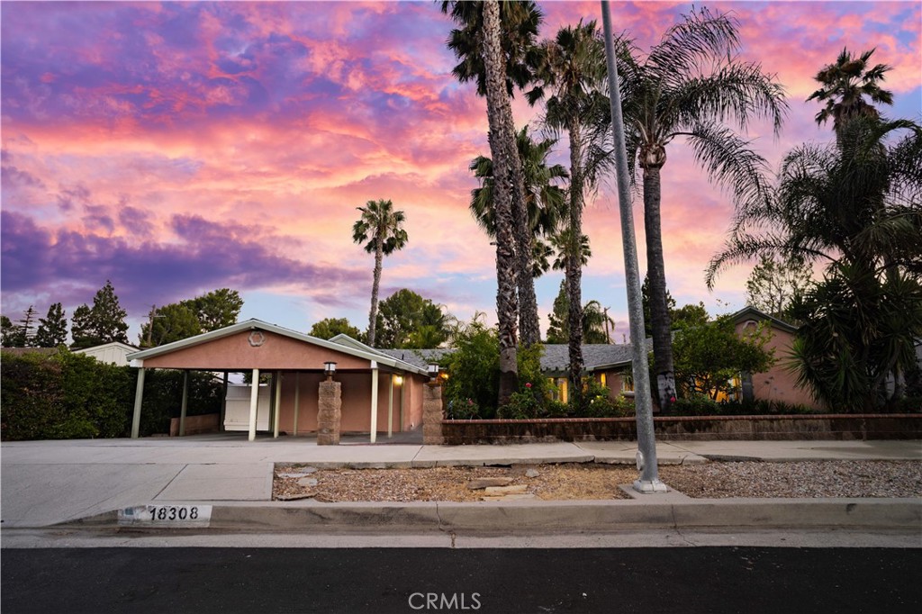 18308 Lahey Street Porter Ranch, CA 91326 - Photo 36 of 41 a front view of a house with a yard and palm trees